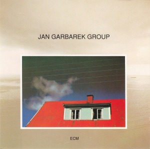 Jan Garbarek Group / Photo With Blue Sky, White Cloud, Wires, Windows And A Red Roof
